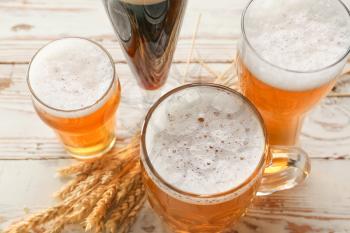 Glassware with fresh beer on table�
