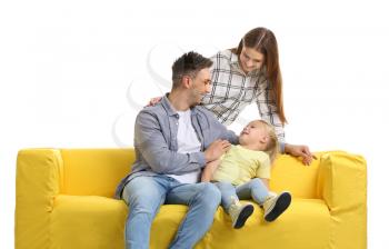 Happy young family with sofa on white background�