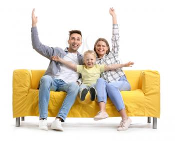 Happy young family sitting on sofa against white background�