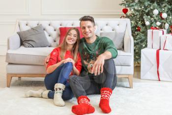 Happy young couple on Christmas eve at home�