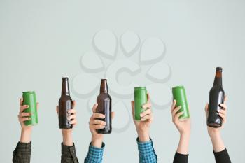Hands with different beer on grey background�