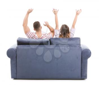 Young couple sitting on sofa against white background, back view�