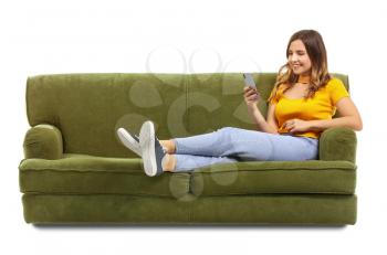 Young woman with mobile phone sitting on sofa against white background�