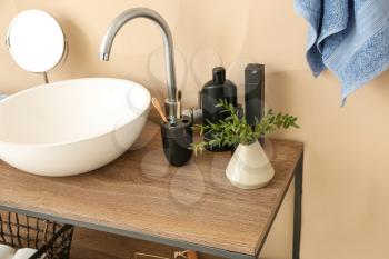 Body care cosmetics with accessories near sink in bathroom�