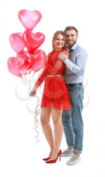 Happy young couple with heart-shaped balloons on white background. Valentine's Day celebration�
