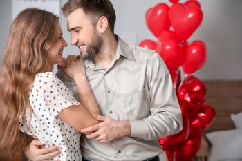 Happy young couple celebrating Valentine's Day at home�
