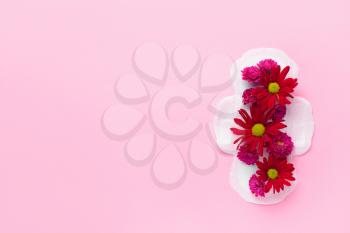 Menstrual pad with flowers on color background. Menstruation concept�