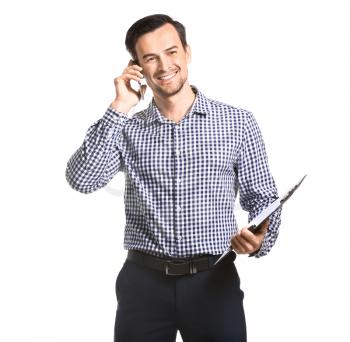 Male real estate agent talking by mobile phone on white background�