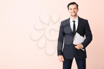 Male real estate agent on color background�