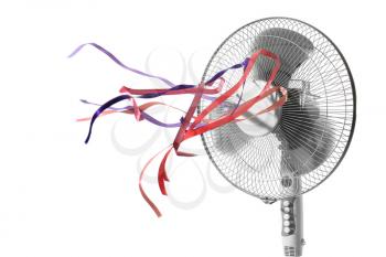 Electric fan with fluttering ribbons on white background�