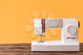 Sewing machine on wooden table�