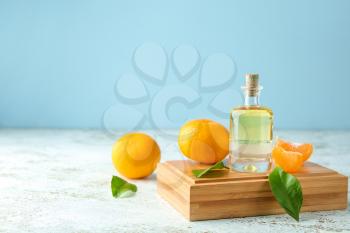 Bottle of tangerine essential oil on table�