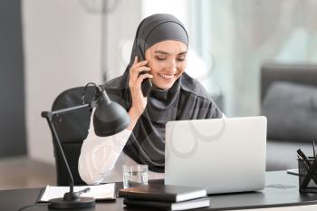 Beautiful Arab businesswoman working in office�