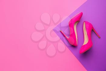 Stylish female shoes on color background�