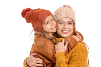Woman and her little daughter in winter clothes on white background�