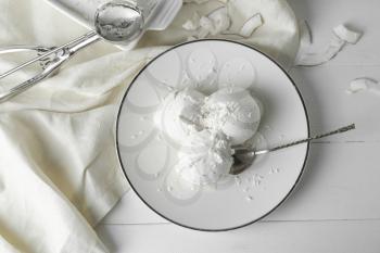Plate with tasty coconut ice-cream on table�
