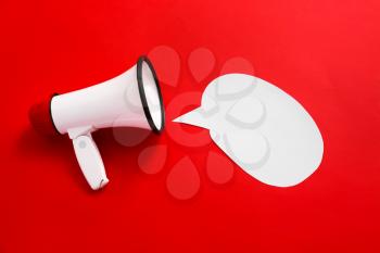 Megaphone with speech bubble on color background�