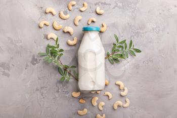 Bottle of cashew milk on grunge background�