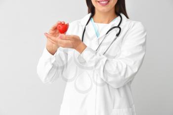 Female cardiologist on light background�
