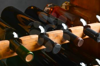Wooden holder with bottles of wine in cellar�