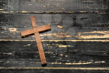 Christian cross on dark wooden background�