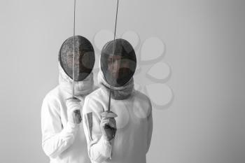 Young fencers on light background�