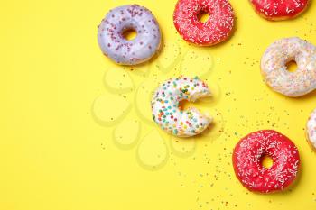 Sweet tasty donuts on color background�