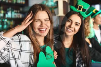 Young women celebrating St. Patrick's Day in pub�