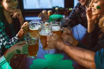 Young friends celebrating St. Patrick's Day in pub�