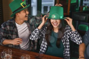 Young friends celebrating St. Patrick's Day in pub�