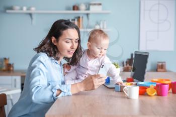 Working mother with her baby at home�