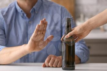 Man refusing to drink beer at home. Concept of alcoholism�