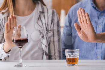 Couple refusing to drink wine and whiskey. Concept of alcoholism�
