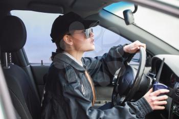Female police officer driving car�