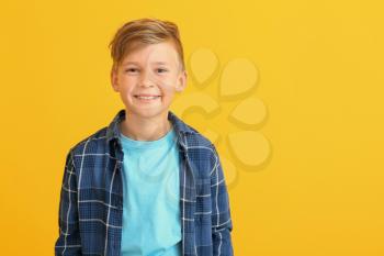 Happy little boy with healthy teeth on color background�