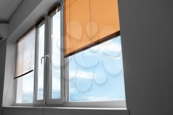 Modern blinds hanging on window�