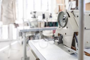 Modern sewing equipment in tailor workshop�