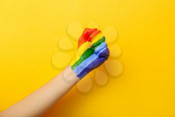 Female hand with painted rainbow on color background. LGBT concept�
