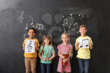 Little children near chalkboard at music school�