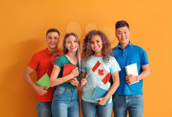 Young students of language school on color background�