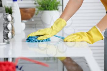 Young woman cleaning her kitchen�