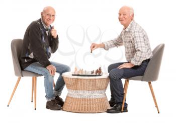 Portrait of elderly men playing chess on white background�