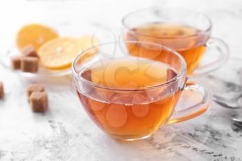 Cups of hot tea on white background�