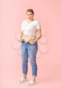 Overweight woman on color background. Weight loss concept�