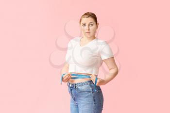 Overweight woman with measuring tape on color background. Weight loss concept�