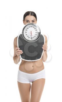 Young woman with scales on white background. Weight loss concept�