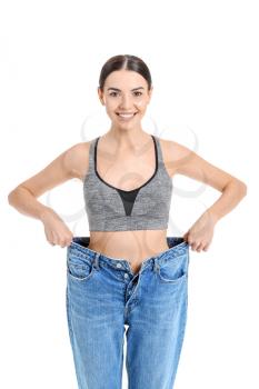 Young woman in loose clothes on white background. Weight loss concept�