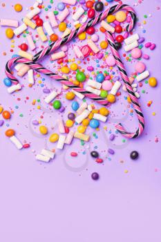 Assortment of tasty candies on color background�