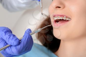 Teenage girl with dental braces visiting orthodontist in clinic�