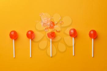 Tasty lollipops on color background�